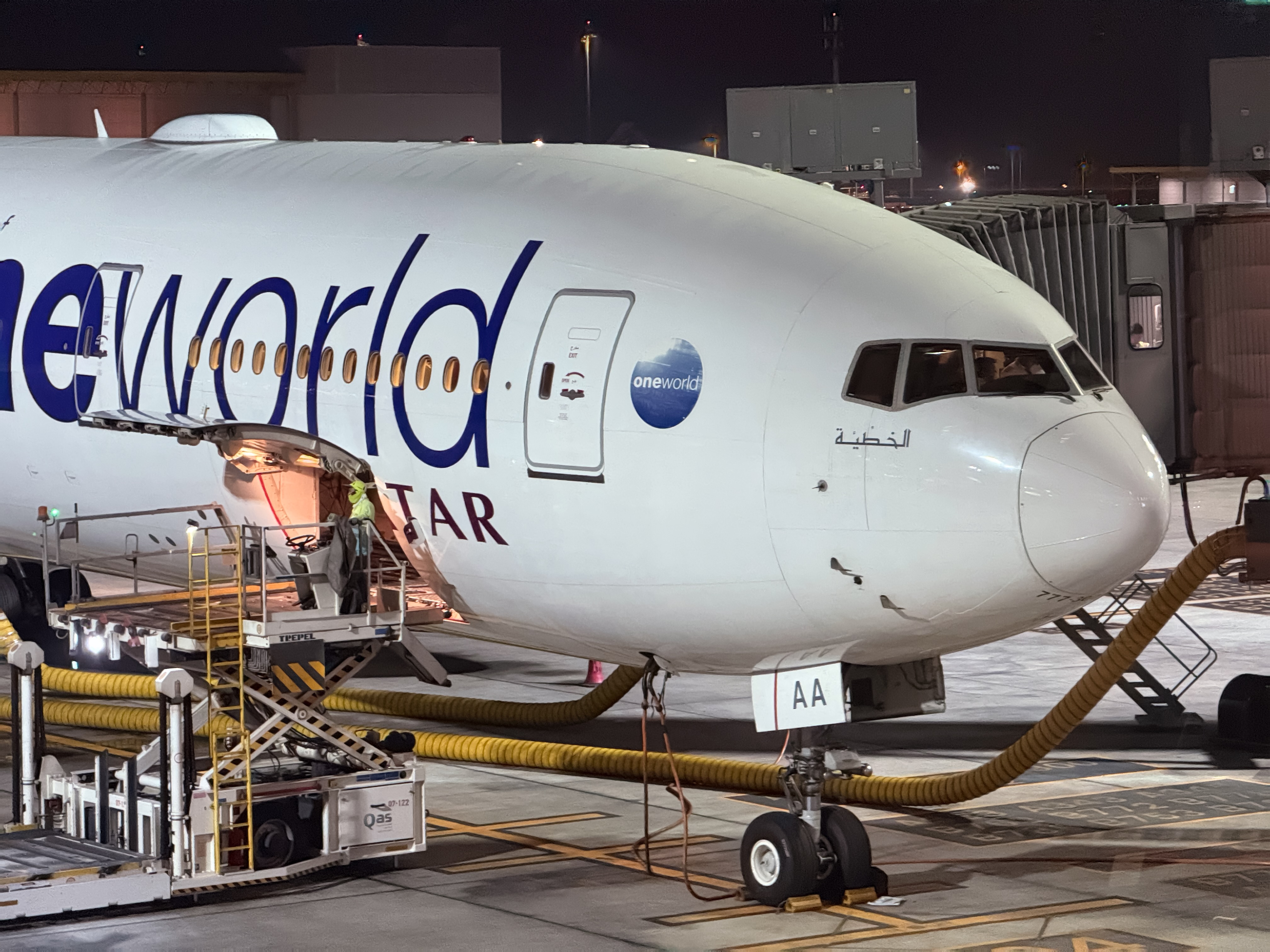 Qatar Airways aircraft nose photographed at night on the ground.